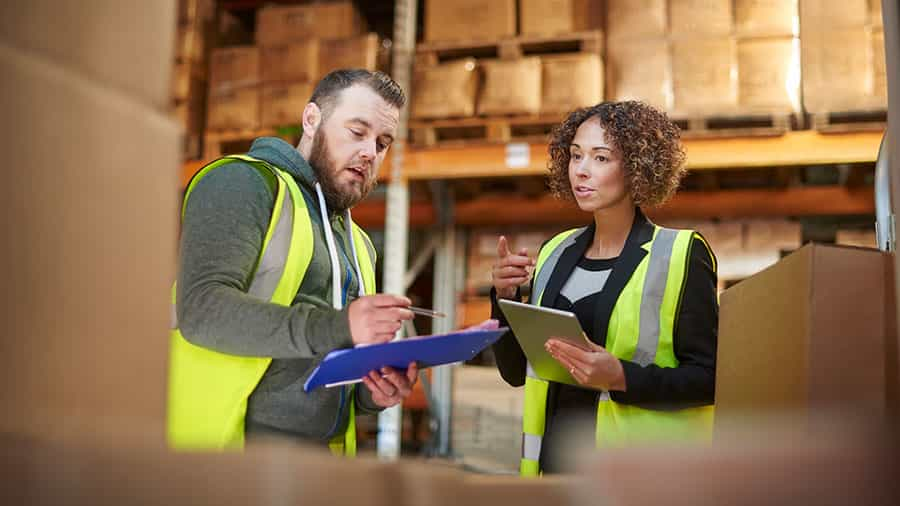 warehouse workers discussing industrial logistics